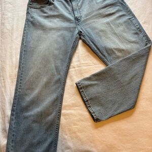 Vintage pair of Levi 505 regular fit straight leg jeans in light blue wash.